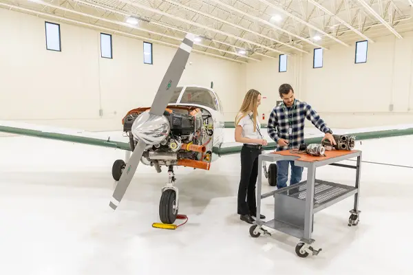 Two students studying airplane engine